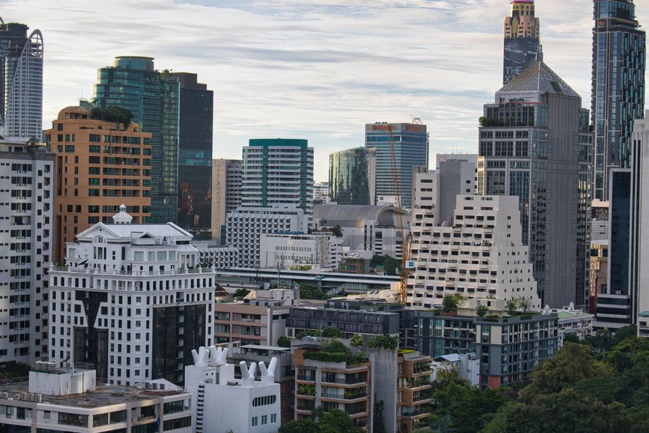 Stylish skyline of Bangkok featuring modern high-rise buildings under a clear blue sky.