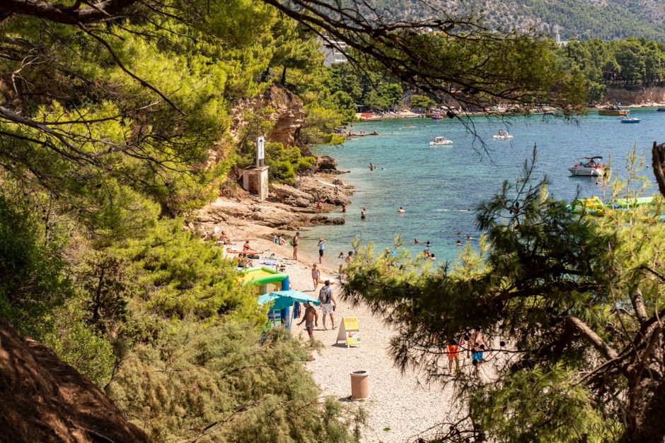 Scenic view of a beach in Bol, Croatia with tourists enjoying the summer sun.