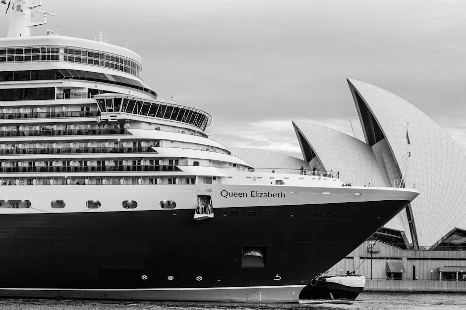 Black and white photo of Queen Elizabeth cruise ship beside the iconic Sydney Opera House.