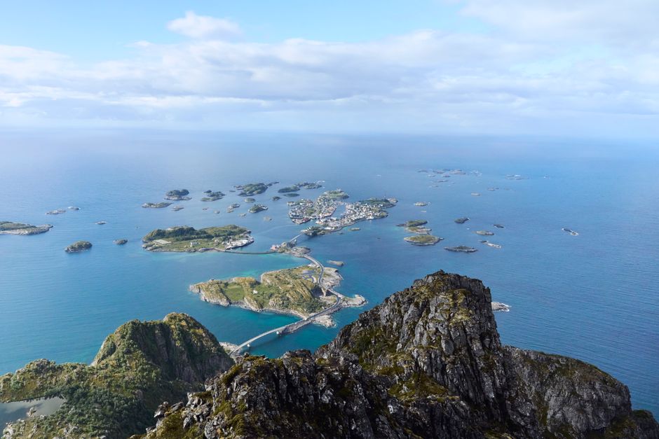 A breathtaking aerial view of the Lofoten Islands showcasing rugged coastline and deep blue sea.