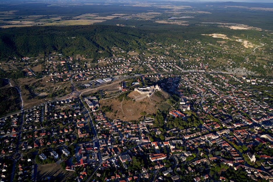 Stunning aerial view of Sümeg Castle and residential areas in Hungary during daylight.
