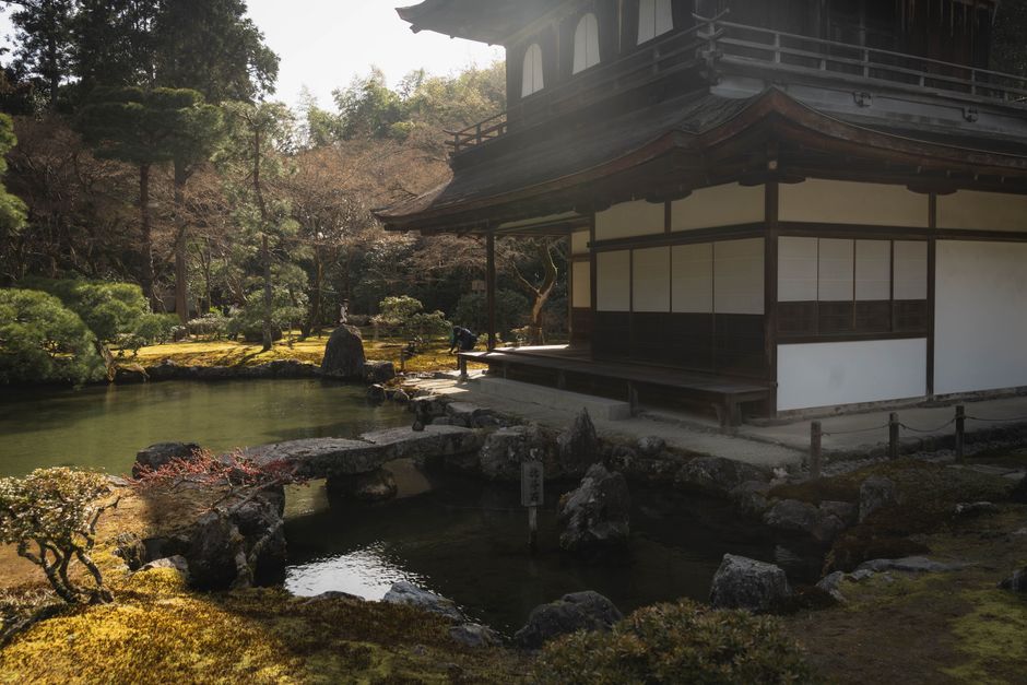 Tranquil view of a traditional Japanese garden in Kyoto, Japan with a pond and pavilion.