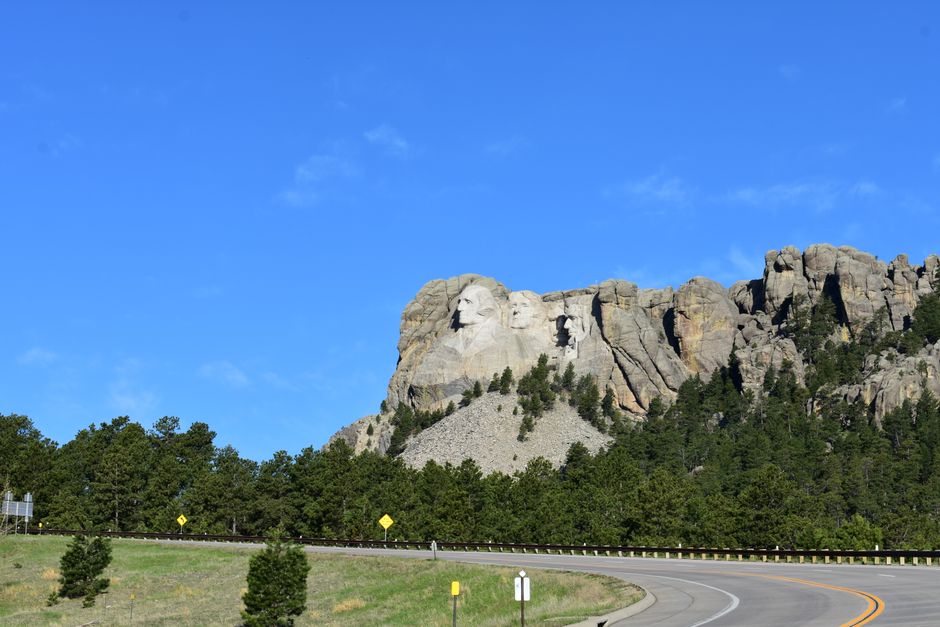Explore Mount Rushmore under a clear blue sky, capturing an iconic American landmark.