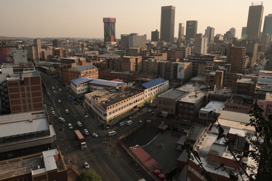 Scenic aerial view of Johannesburg cityscape showcasing urban architecture in warm evening light.