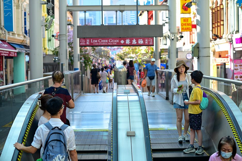 Bustling day at an MRT entrance in Singapore's vibrant Chinatown.