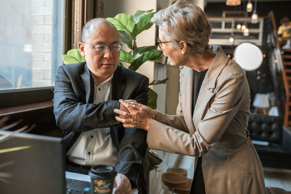 Two professionals engaged in conversation in a modern coworking environment.
